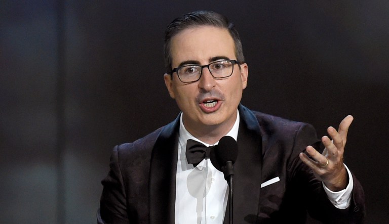 John Oliver speaks at an event.