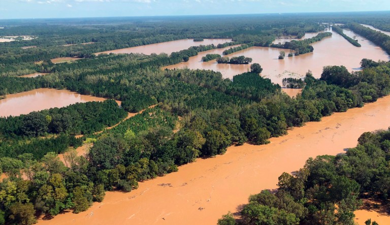 This Monday, Sept. 17, 2018 photo shows rising flood waters in the Pee Dee area in Marion County, S.C. Two female mental health patients detained for medical transport drowned Tuesday, Sept. 18, when a sheriff's department van was swept away in rising floodwaters, according to authorities.  Officials said that the transport van was near the Little Pee Dee River, one of the bodies of water that state officials are watching following the heavy rains of Florence.