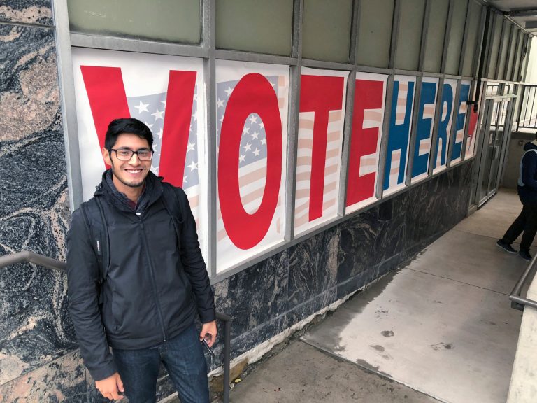 Minnesota Democratic-Farmer-Labor Party activist Manilan Houle, of Minneapolis, is the first person waiting in line outside a polling station in downtown Minneapolis on Friday, Sept. 21, 2018, on the first day of early voting in Minnesota in the 2018 midterm elections.