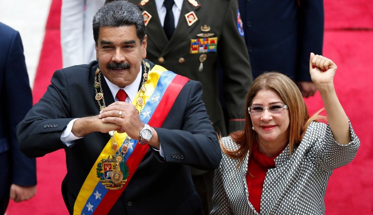 FILE - In this May 24, 2018 file photo, Venezuela's President Nicolas Maduro, left, and first lady Cilia Flores, acknowledge the press corps as they arrive for a session with the Constituent Assembly, in Caracas, Venezuela. Maduro has moved to assert even greater control over food distribution, handing out monthly boxes of staples that critics label a form of dictatorial social control.