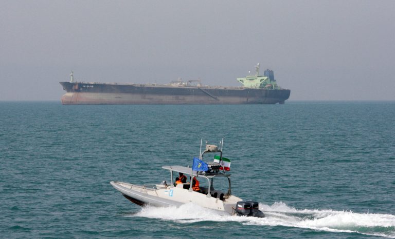 In this July 2, 2012 photo, an Iranian Revolutionary Guard speedboat moves in the Persian Gulf while an oil tanker is seen in background. 
