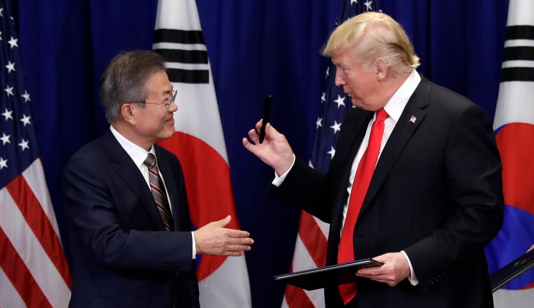 President Trump hands a pen he used to South Korean President Moon Jae-in at a signing ceremony for the United States-Korea Free Trade Agreement at the Lotte New York Palace hotel during the United Nations General Assembly, Sept. 24, 2018, in New York.