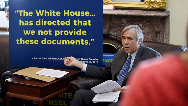 Sen. Jeff Merkley, D-Ore., talks with reporters.