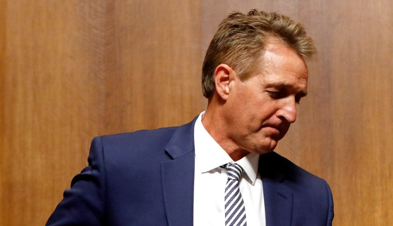 Sen. Jeff Flake, R-Ariz., walks past Sen. Orrin Hatch and Senate Judiciary Committee Chairman Chuck Grassley of Iowa during a Senate Judiciary Committee hearing on Supreme Court nominee Judge Brett Kavanaugh on Capitol Hill in Washington.