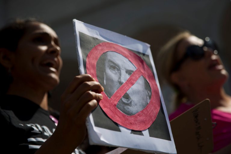 Two women chant their slogan outside Los Angeles City Hall during a protest against Supreme Court nominee Brett Kavanaugh Friday, Sept. 28, 2018, in Los Angeles.