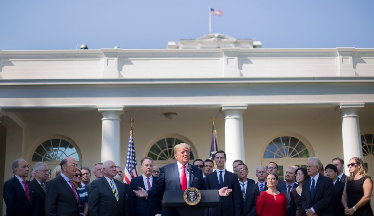President Trump, center, speaks as he announces a revamped North American free trade deal, in the Rose Garden of the White House in Washington, Monday, Oct. 1, 2018. The new deal, reached just before a midnight deadline imposed by the U.S., will be called the United States-Mexico-Canada Agreement, or USMCA. It replaces the 24-year-old North American Free Trade Agreement.