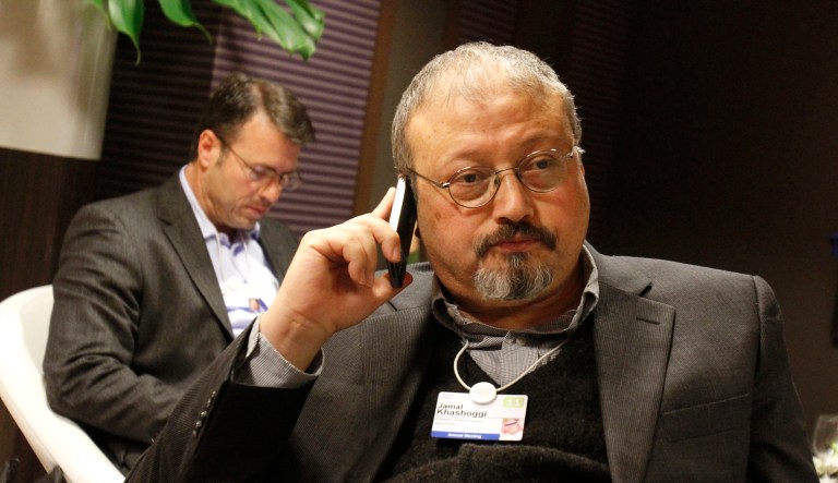 In this 2011 file photo, Saudi Arabian journalist Jamal Khashoggi speaks on his cellphone at the World Economic Forum in Davos, Switzerland.