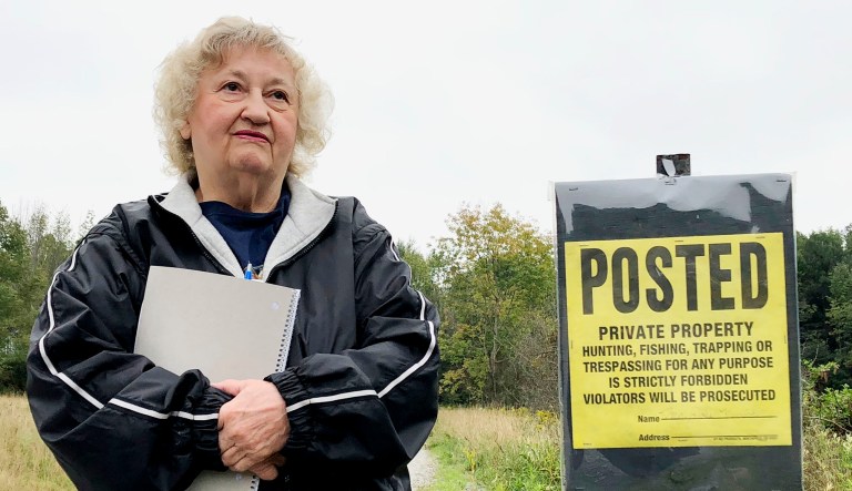 Pennsylvania resident Rose Mary Knick stands next to a private property sign on her farmland in Lackawanna County's Scott Township. Knick is at the center of a case the Supreme Court is hearing that stems from Knick's dispute with her town over an ordinance that says landowners who have cemeteries on their properties must make them open to the public during daylight hours. 