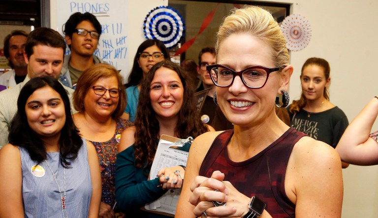 Democratic Rep. Kyrsten Sinema, who is running against Republican Rep. Martha McSally for the open Arizona Senate seat Jeff Flake, R-Ariz., is vacating, appears with campaign volunteers in Tempe, Ariz.