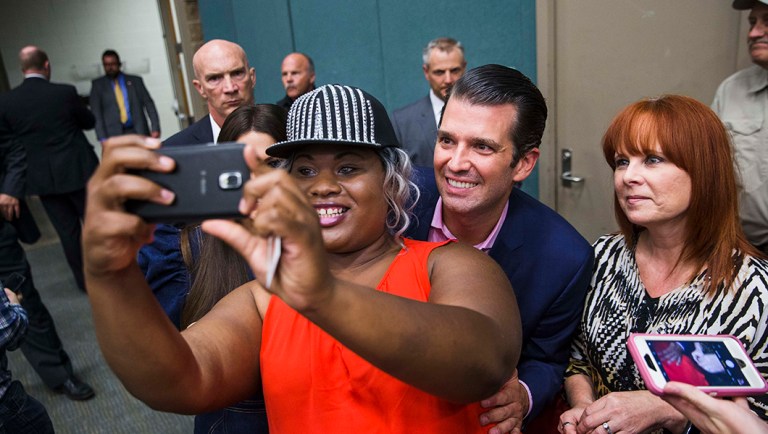 Donald Trump Jr. takes a photo with local resident.