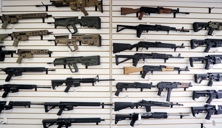 In this Oct. 2, 2018 photo, semi-automatic rifles fill a wall at a gun shop in Lynnwood, Wash. 