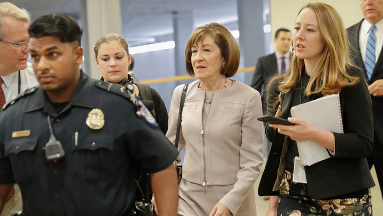 Sen. Susan Collins, R-Maine, is followed by members of the media as she walks to the Capitol before a vote.