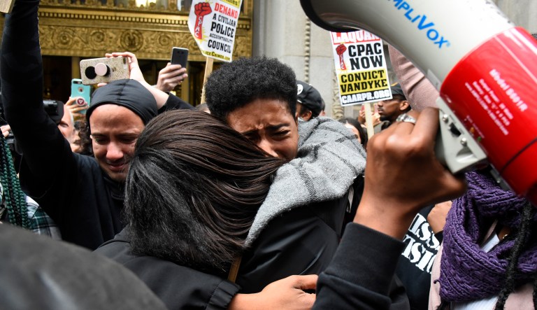 People react outside the city hall in Chicago on Friday, Oct 5, 2018, after a jury convicted Chicago Police Officer Jason Van Dyke of second-degree murder in the 2014 shooting of Laquan McDonald. The white Chicago officer was convicted of second-degree murder Friday in the shooting of the black teenager that was captured on shocking dashcam video that showed him crumpling to the ground in a hail of 16 bullets as he walked away from police.