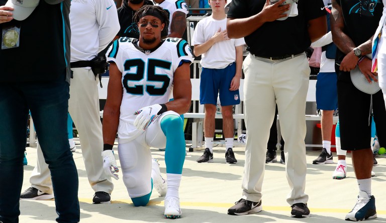 Carolina Panthers' Eric Reid (25) kneels as Cam Newton (1) stands during the national anthem before an NFL football game against the New York Giants in Charlotte, N.C., Sunday, Oct. 7, 2018.
