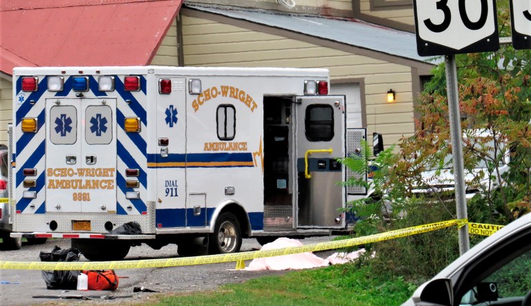 In this Saturday, Oct. 6, 2018 photo, a body is draped under a blanket at the scene of a fatal crash in Schoharie, N.Y.