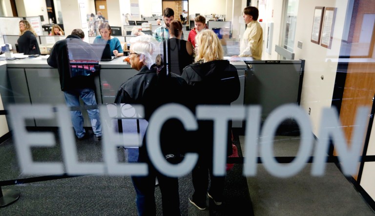 Local residents wait in line for their ballot at an election office.