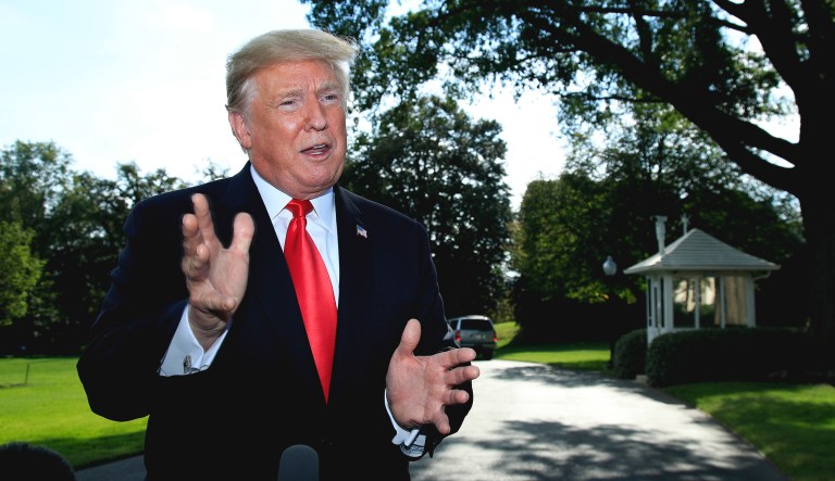President Trump speaks to reporters on the South Lawn before leaving the White House in D.C. on Tuesday.