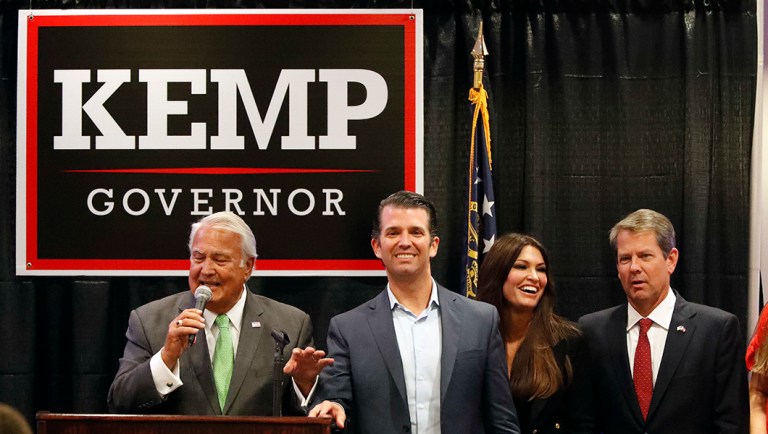 Georgia Pubic Service Commission Chairman Lauren "Bubba'" McDonald, left, sings as he stands on stage with Donald Trump Jr., Kimberly Guilfoyle and Republican nominee for Georgia Gov. Brian Kemp.