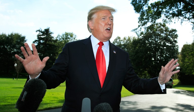 President Trump speaks to reporters on the South Lawn before leaving the White House in Washington.