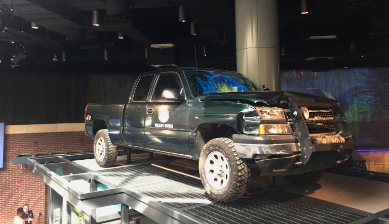 This Thursday, Oct. 11, 2018, photo shows a pickup truck of the Arkansas Game and Fish Commission that commission officer Michael Neal used to stop the van of two men who killed police officers in 2010, displayed at the National Law Enforcement Museum in Washington, D.C. Neal, now the Monroe County Sheriff, who risked death by ramming his truck in the van of a father and son who killed two West Memphis police officers in 2010, is featured in the museum, which opens this weekend in Washington.