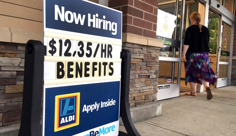 FILE- In this July 17, 2018, file photo, a sign outside a business in Salem, N.H. says "Now Hiring." On Tuesday, Oct. 16, the Labor Department reports on job openings and labor turnover for August.