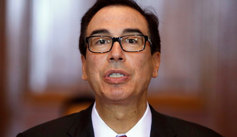 Treasury Secretary Steve Mnuchin leads a meeting of the Financial Stability Oversight Council, Tuesday, Oct. 16, 2018, at the Treasury Department in Washington. The Treasury Department on Tuesday targeted a network of banks and businesses that provides financial support to a paramilitary force in Iran, which allegedly trains and deploys child soldiers to fight with Iran's Islamic Revolutionary Guard Corps. 