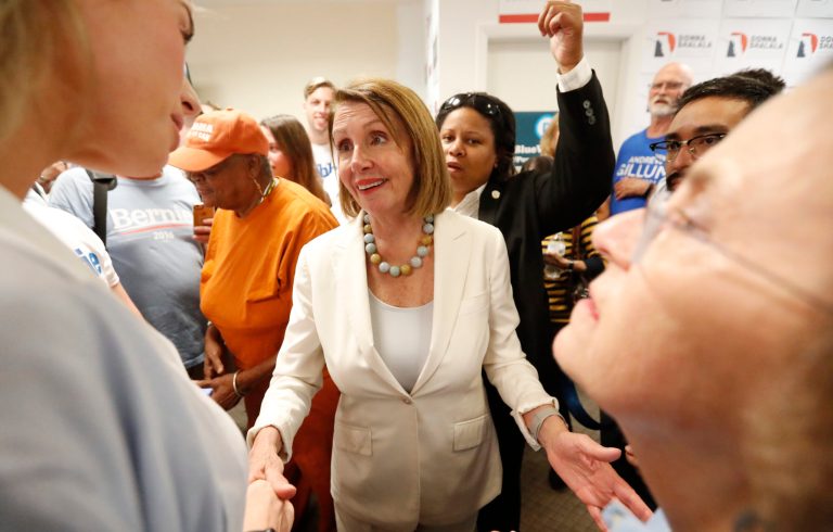 House Minority Leader Nancy Pelosi, center, who would be speaker in a Democratic House rout,  speaks to volunteers after a get out the vote event for Florida Democratic congressional candidates Donna Shalala and Debbie Mucarsel-Powell, Wednesday, Oct. 17, 2018, in Coral Gables, Fla.
