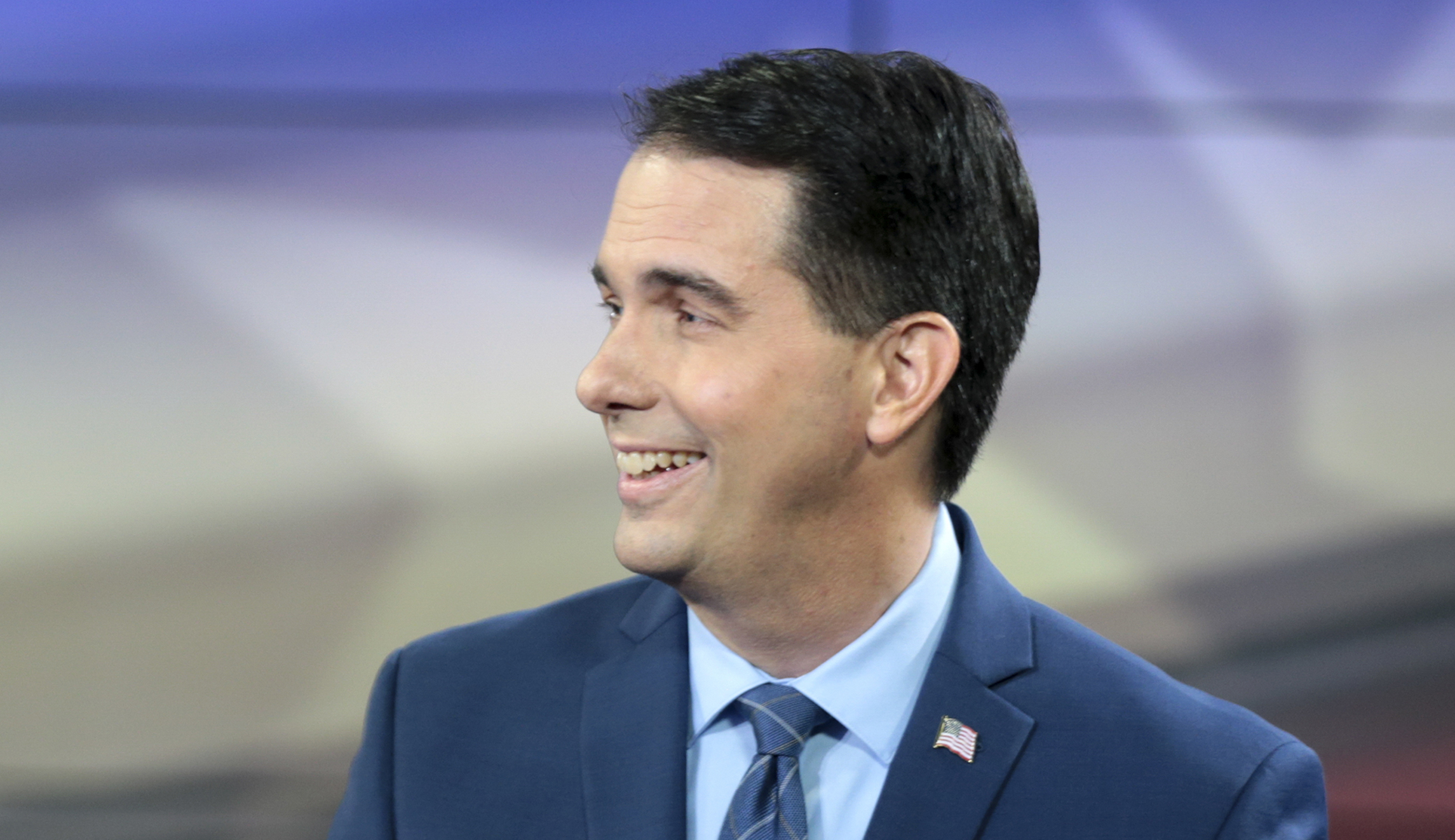 Scott Walker on the defensive over pre-existing conditions