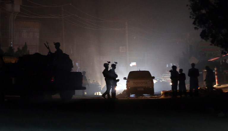 Security forces block the main road at the site of a suicide attack during the first day of parliamentary election in Kabul, Afghanistan, Saturday, Oct. 20, 2018. Police say a suicide bomber blew himself up in front of a polling station in a school in the northern Kabul neighborhood of Khair Khana, the first major attack in Saturday's parliamentary elections.