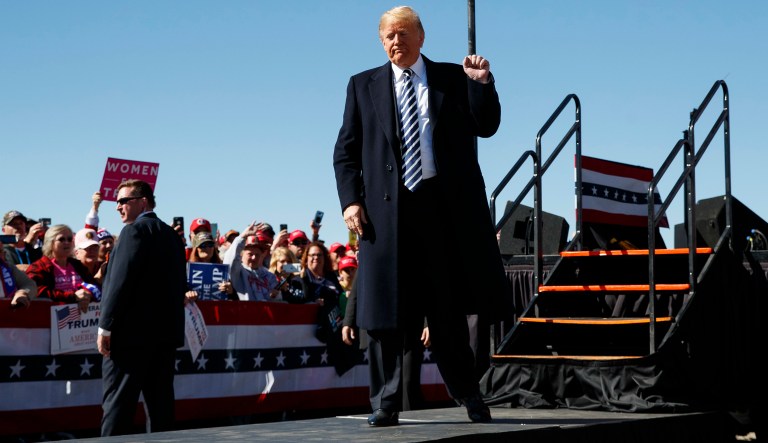 President Donald Trump gestures as he walks from the stage at Elko Regional Airport, Saturday, Oct. 20, 2018, in Elko, Nev., after speaking during a campaign rally.