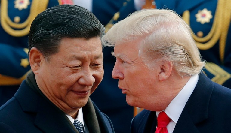 In this Nov. 9, 2017, file photo, President Trump chats with Chinese President Xi Jinping during a welcome ceremony at the Great Hall of the People in Beijing.