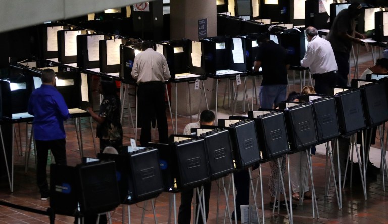 People vote on the first day of early voting in Miami-Dade County, Monday, Oct. 22, 2018, in Miami.