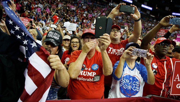 Supporters of President Trump cheer as he arrives for a campaign rally.