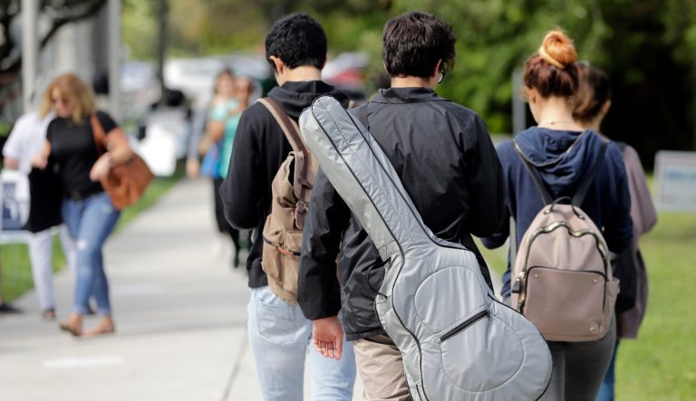Students walk on the campus of Miami Dade College, in Miami, Tuesday, Oct. 23, 2018.