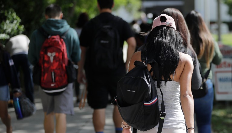 In this Tuesday, Oct. 23, 2018 photo, students walk on the campus of Miami Dade College, in Miami.