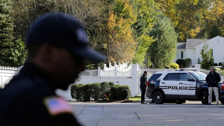 Police officers stand in front of property owned by former Secretary of State Hillary Clinton and former President Bill Clinton.
