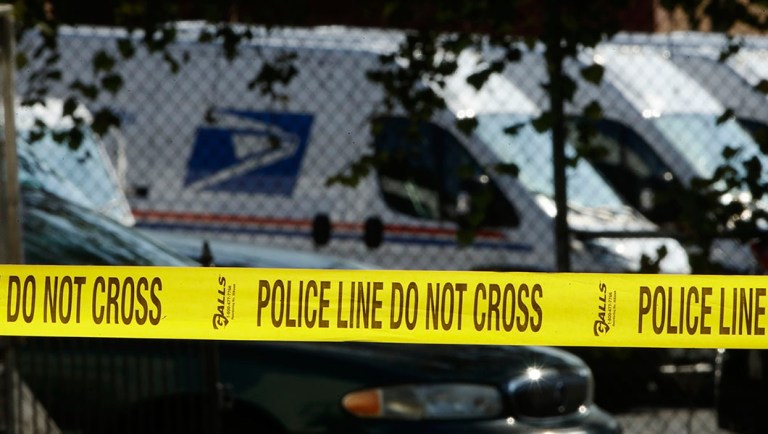 Police tape cordons off a post office in Wilmington, Del.