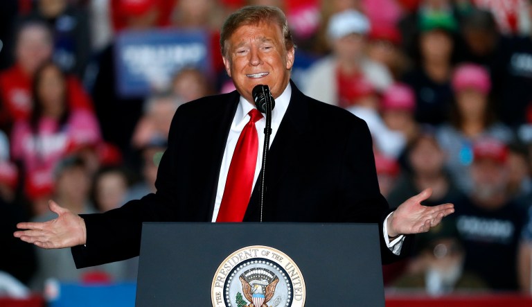 In this Oct. 27, 2018, photo, President Donald Trump speaks during a rally at Southern Illinois Airport in Murphysboro, Ill. Eager to focus voters on immigration in the lead-up to the midterm elections, Trump on Oct. 29 escalated his threats against a migrant caravan trudging slowly toward the U.S. border as the Pentagon prepared to deploy thousands of U.S. troops to support the border patrol.