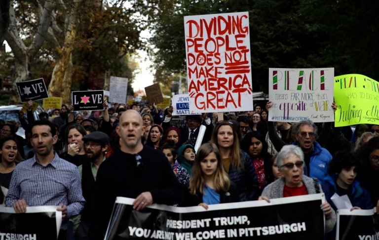 Protesters demonstrate near Pittsburgh's Tree of Life Synagogue where President Donald Trump and first lady Melania Trump were visiting a memorial in Pittsburgh, Tuesday, Oct. 30, 2018. The Trumps came to Pittsburgh to honor the victims of a mass shooting at the synagogue last week.