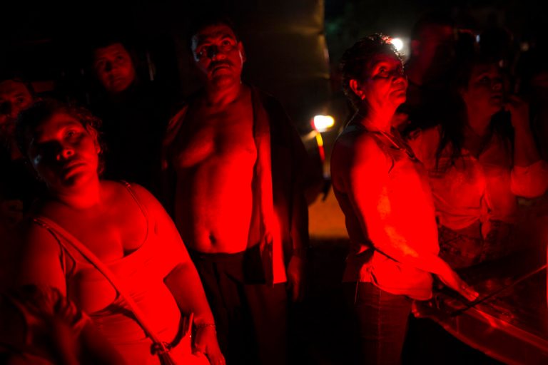 Honduran migrants, part of the thousands-strong caravan of Central Americans migrants hoping to reach the U.S.,  listen that there was no more donated food for them, at a makeshift shelter in Matias Romero, Oaxaca state, Mexico, Thursday, Nov. 1, 2018. 