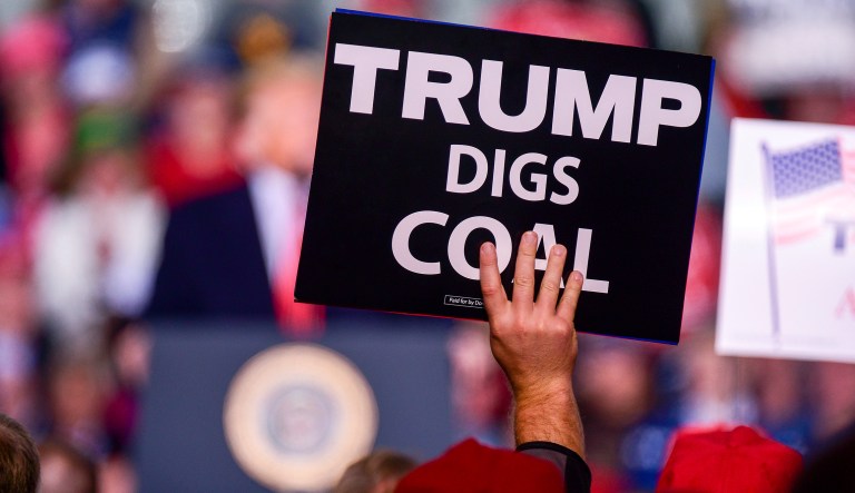 A supporter holds a sign as President Donald Trump speaks at a rally, Friday, Nov. 2, 2018, at the Tri-State Airport in Huntington, W.Va.