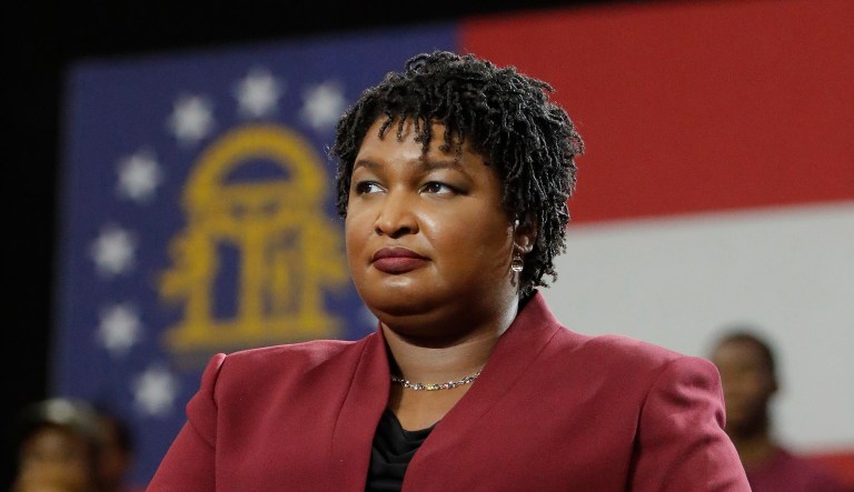 Georgia gubernatorial candidate Stracey Abrams watches as former President Barack Obama speaks during a campaign rally at Morehouse College, Friday, Nov. 2, 2018, in Atlanta.