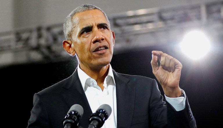 Former President Barack Obama steps on stage to speak.