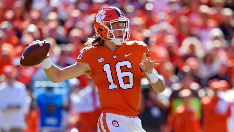 Clemson's Trevor Lawrence drops back to pass during the first half of an NCAA college football game against Louisville.