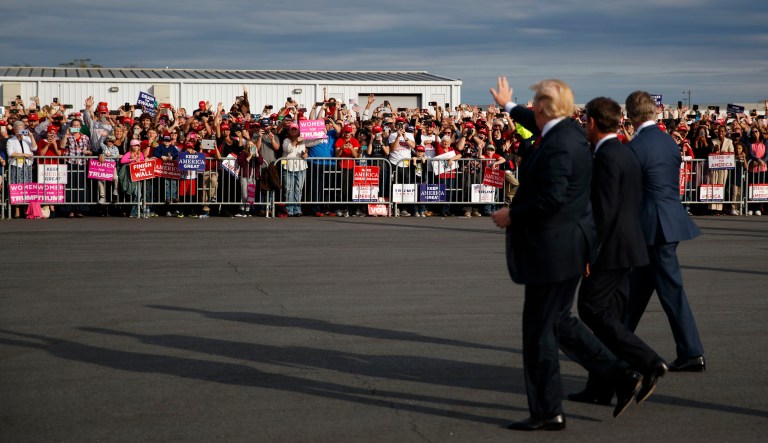 President Donald Trump waves as he arrives to speak at a campaign rally, Sunday, Nov. 4, 2018, in Macon, Ga.