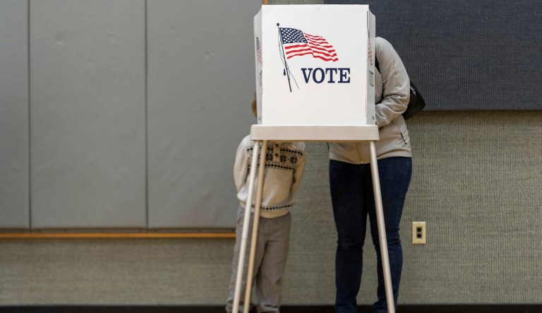 Democratic congressional candidate Amy McGrath stands stands in the voting booth with her son Theodore on Election Day in Georgetown, Ky., Tuesday, Nov. 6, 2018.