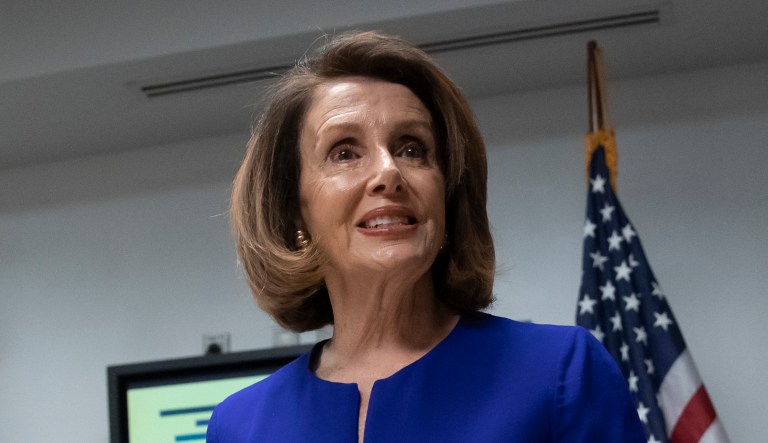 House Democratic Leader Nancy Pelosi of California,smiles as she meets with reporters on Election Day at the Democratic National Committee headquarters in D.C.