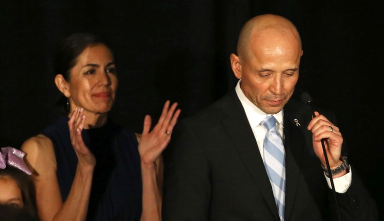 Democratic candidate for Arizona governor David Garcia (pictured right) pauses as he gives his concession speech while his wife, Lori (pictured left), applauds at an election night gathering for Democrats on Tuesday in Phoenix.