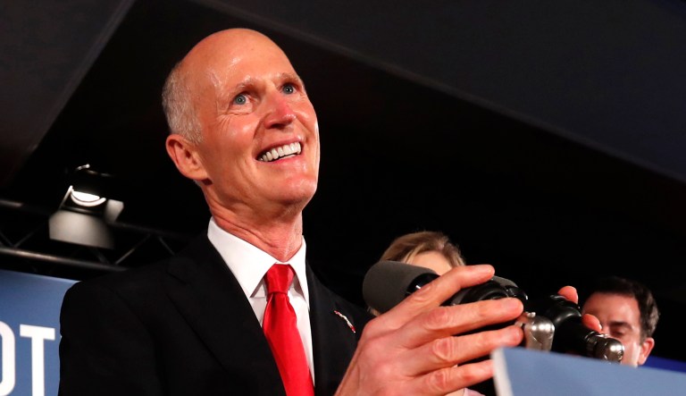 Republican Senate candidate Rick Scott smiles as he speaks to supporters at an election watch party in Naples, Fla. 
