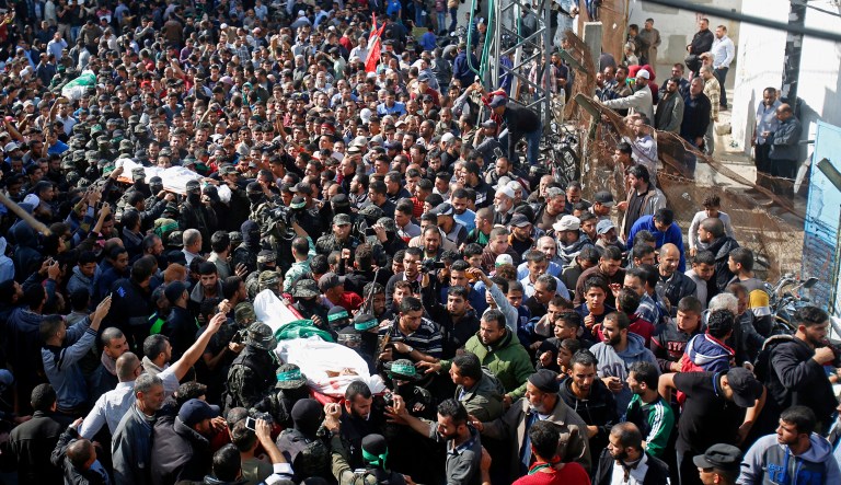 Palestinian mourners carry the bodies of two of the seven Hamas militants who were killed in an Israeli raid late Sunday, during their funerals in Khan Younis, southern Gaza Strip, Monday, Nov. 12, 2018. Thousands of mourners in the Gaza Strip buried seven Palestinians, including a local Hamas commander, killed after an Israeli incursion into the territory, which also killed one Israeli army officer. The cross-border fighting came just days after Israel and Hamas reached indirect deals, backed by Qatar and Egypt, to allow cash and fuel into Gaza.